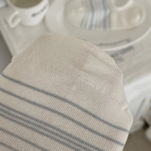 Detailed macro view of seamless toe stitching on striped cotton low-cut liner socks