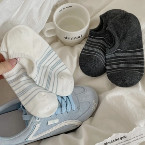 Close-up of striped cotton blend no-show socks in white and grey for casual wear