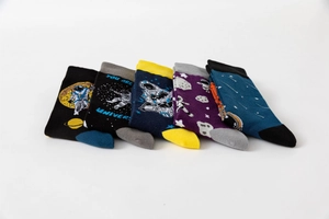 Detail of five pairs of space-themed crew socks with astronaut and planet knit patterns