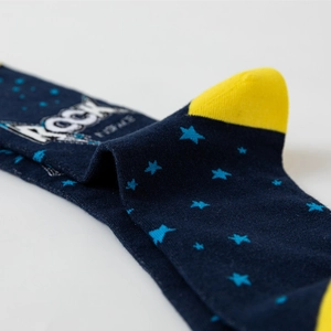 Macro shot of navy blue astronaut socks featuring star patterns and reinforced yellow heel