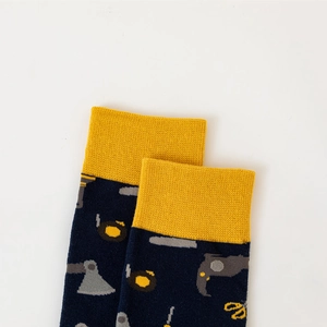 Detailed knit texture of navy crew socks with yellow cuffs and tool pattern motifs
