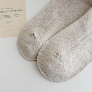 Close-up of the toe detail on light grey ballet-style knit socks with ribbed texture