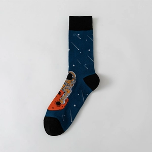 Macro shot of navy blue crew socks featuring astronaut and planet embroidery detail