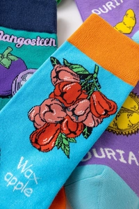 Detail of cotton crew socks featuring colorful tropical fruit patterns like mangosteen and durian