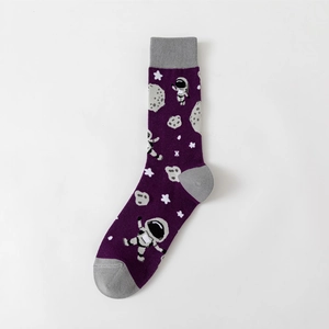 Detail of crew sock featuring knitted astronauts and meteor patterns on purple fabric