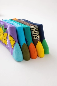 Detail of five colorful cotton socks with tropical fruit patterns and SUMM lettering