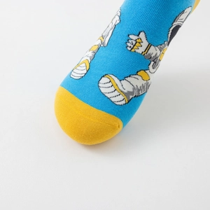 Detail of blue astronaut socks with contrasting yellow toe and knitted pattern