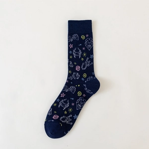 Detailed view of dark blue socks with white constellations and pink star patterns