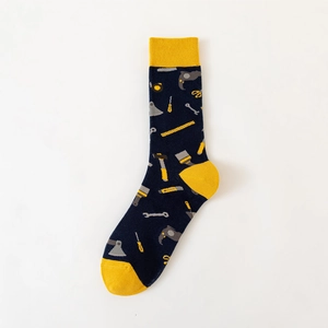 Detail of cotton crew socks featuring navy blue fabric with yellow accents and tool patterns