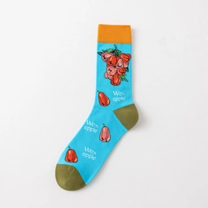 Detail of blue cotton crew sock featuring red wax apple patterns and orange ribbed cuffs
