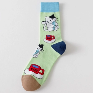 Detail of green cotton sock featuring cute cartoon cat with fish and cat mug pattern