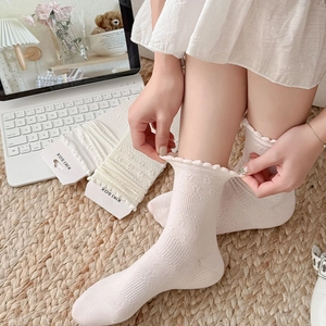 Chic cream-colored mid-calf socks with ruffle lace trim and jacquard floral texture