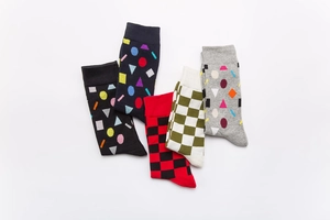 Detailed view of five pairs of cotton crew socks featuring colorful geometric patterns