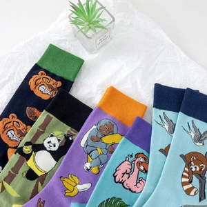Flat lay of colorful mid-calf cotton socks with vibrant cartoon animal embroidery patterns