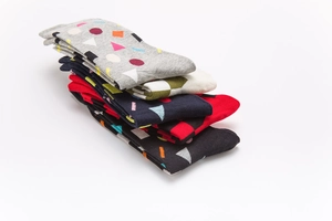 Detail of stacked cotton socks with colorful geometric patterns in various colors