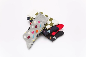 Detail view of cotton crew socks featuring colorful geometric patterns and ribbed cuffs