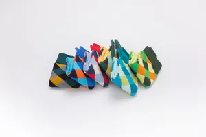 Detail of colorful argyle pattern men's mid-calf socks with elastic ribbed cuffs