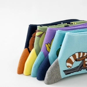 Close-up of five pairs of cotton socks featuring colorful animal jacquard patterns