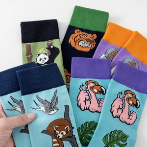 Detail of colorful animal pattern mid-calf cotton socks with vibrant rib knit cuffs