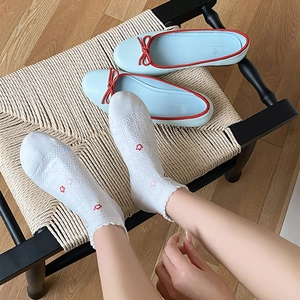 White lace socks with red floral embroidery paired with light blue bow ballet flats