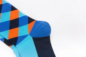 Detailed close-up of colorful argyle knit crew socks with blue and orange patterns