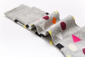 Detailed view of grey mid-calf socks with colorful geometric patterns in combed cotton