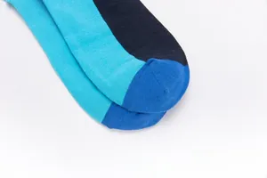 Detailed close-up of smooth toe seam on color-block blue and black knitted socks