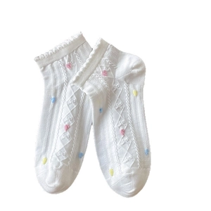 White lace ankle socks for women with colorful polka dots and a ruffled cuff design
