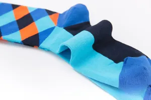 Detailed close-up of blue and orange argyle pattern cotton crew socks for men