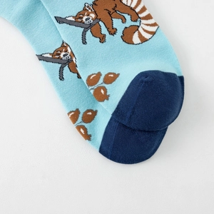 Detailed knit texture of light blue cotton socks with panda print and blue toe