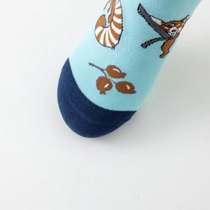 Close-up of knitted cotton sock fabric showing red panda patterns and soft texture