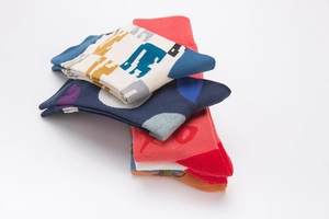 Macro shot of breathable cotton socks with colorful polka dots and pixel patterns