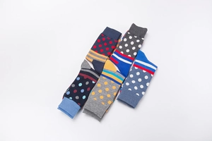 Close-up of five pairs of colorful polka dot and geometric striped mid-calf cotton socks