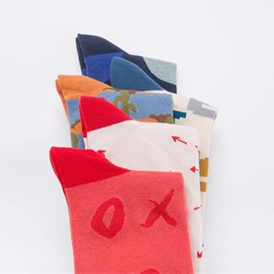 Four pairs of assorted cotton crew socks with jacquard patterns in vibrant colors and textures
