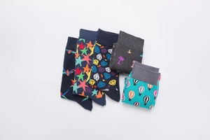 Flat lay of five pairs of assorted cotton crew socks with colorful geometric patterns