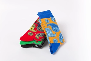 Detail of colorful Paisley patterned crew socks with elastic ribbed cuffs and premium knit