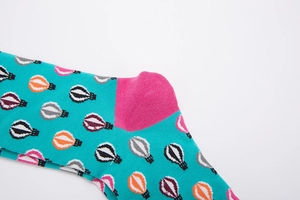 Detailed macro view of cotton socks with hot air balloon patterns and pink heel contrast