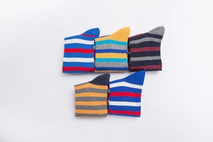 Flat lay of five pairs of cotton striped crew socks in vibrant colorful patterns