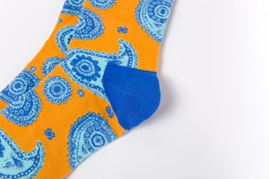 Detailed close-up of orange and blue Paisley pattern knit socks with textured finish