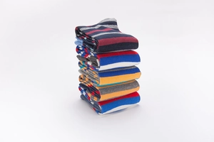 Close-up of stacked colorful striped cotton crew socks in various vibrant color combinations