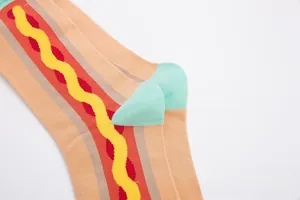 Detail of colorful hot dog print crew socks with stylish orange knit and mint heel