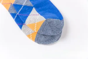 Close-up of argyle knit socks showing detailed stitching in blue and orange cotton