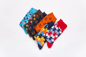 Close-up of six-pack colorful cotton socks featuring geometric and puzzle patterns