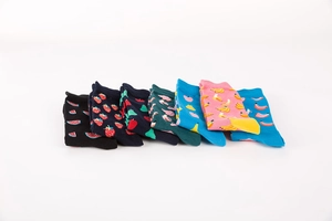 Set of seven colorful crew socks with vibrant fruit patterns on a white background