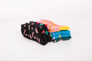 Close-up of crew socks featuring vibrant watermelon, banana and strawberry fruit patterns
