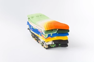 Close-up of stacked colorful cotton crew socks with floral patterns and ribbed cuffs