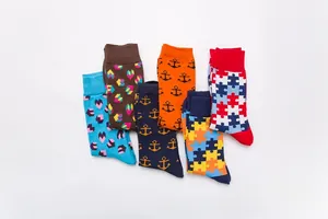Detailed flat lay of six pairs of colorful patterned mid-calf socks with geometric designs