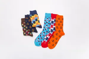 Flat lay of six colorful patterned crew socks featuring jigsaw and geometric prints