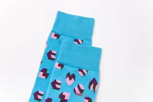 Detailed close-up of sky blue cotton socks with pixel geometric pattern and ribbed cuffs