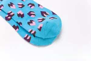 Detailed close-up of sky blue cotton socks with 3D geometric heart puzzle patterns